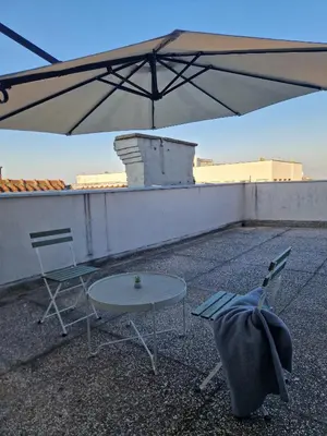 a table and chairs on top of a roof at Apartment Vera in Belgrade