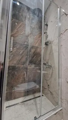 a shower with a glass door in a bathroom at Apartment Vera in Belgrade