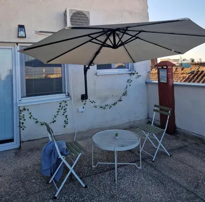 a table and two chairs under an umbrella at Apartment Vera in Belgrade