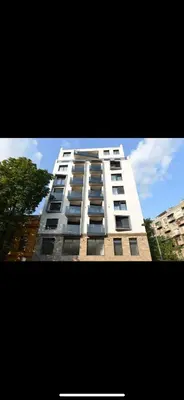 a tall white building with a lot of windows at Apartman Ilija in Belgrade