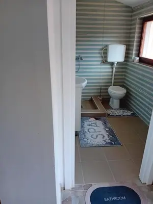 a bathroom with a toilet and a sink at AlejaPark Inđija in Železnicka Stanica Inđija Selo