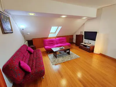 a living room with pink furniture and a flat screen tv at Modern City Center Apartment - Rajiceva Loft in Belgrade