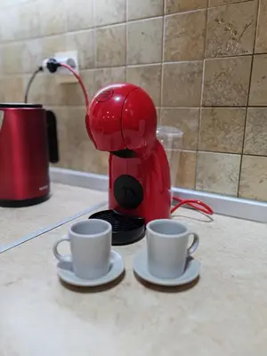 a red coffee maker with two cups on a counter at Modern City Center Apartment - Rajiceva Loft in Belgrade