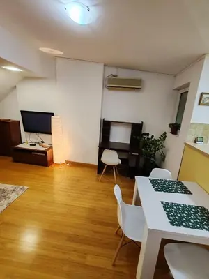 a living room with a table and chairs and a desk at Modern City Center Apartment - Rajiceva Loft in Belgrade