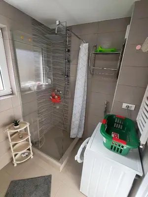 a bathroom with a shower with a glass door at Modern City Center Apartment - Rajiceva Loft in Belgrade