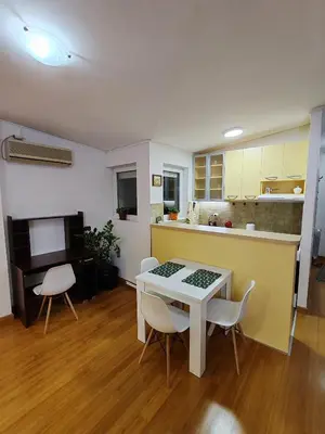 a kitchen and dining room with a table and chairs at Modern City Center Apartment - Rajiceva Loft in Belgrade