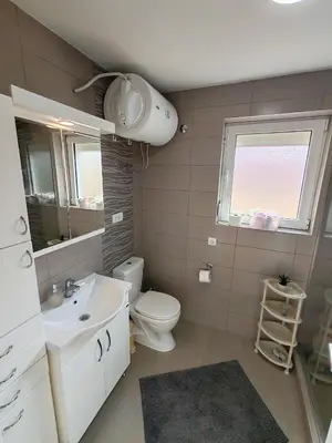 a bathroom with a sink and a toilet and a window at Modern City Center Apartment - Rajiceva Loft in Belgrade