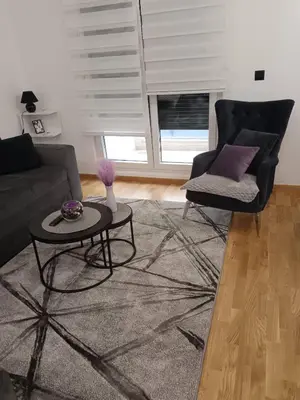 a living room with a couch and a table at City011 studio PRIVATE GARAGE FREE in Belgrade