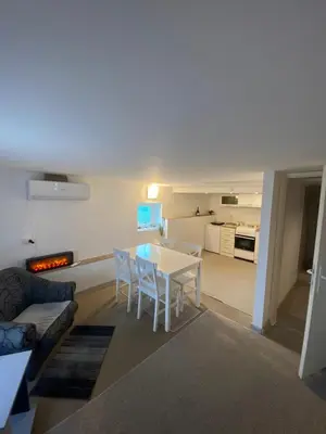 a living room with a white table and chairs at Aurora Apartment in Smederevo