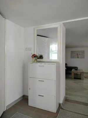a white dresser in a room with a mirror at Aurora Apartment in Smederevo