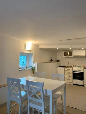 a kitchen with a white table and chairs at Aurora Apartment in Smederevo
