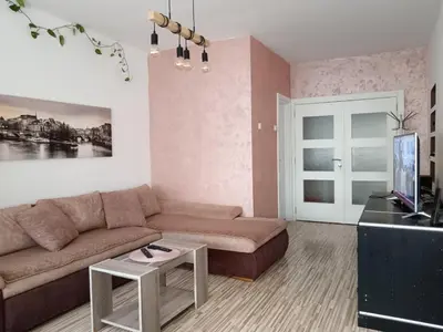 a living room with a couch and a table at Apartman Maki in Belgrade