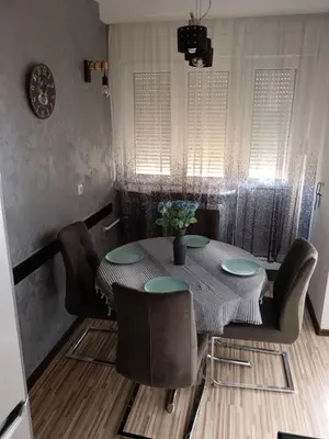 a dining room table and chairs with a table and chairsktop at Apartman Maki in Belgrade
