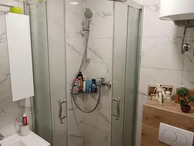 a shower with a glass door in a bathroom at Apartman Maki in Belgrade