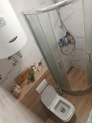 a bathroom with a toilet and a large mirror at Apartman Maki in Belgrade