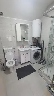 a bathroom with a toilet and a washing machine at Smile 1 in Belgrade