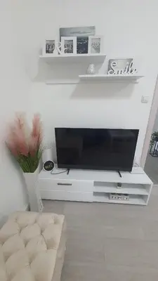 a flat screen tv sitting on a white entertainment center at Smile 1 in Belgrade