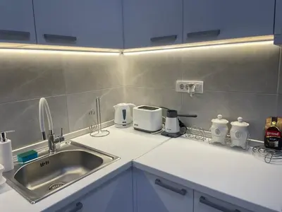 a kitchen counter with a sink and appliances on it at Smile 1 in Belgrade