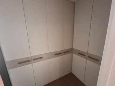 a white closet with white cabinets in a room at Exclusive apartman Belgrade Waterfront Terraces - Unique in Belgrade
