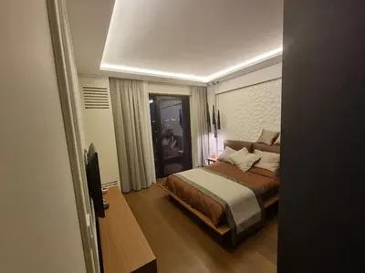 a bedroom with a bed and a tv in it at Exclusive apartman Belgrade Waterfront Terraces - Unique in Belgrade