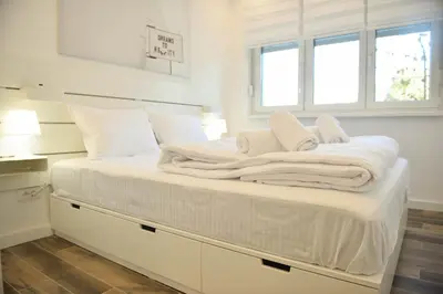 a large white bed with white sheets and pillows at Friendly Home ap Balkan-inn in Belgrade