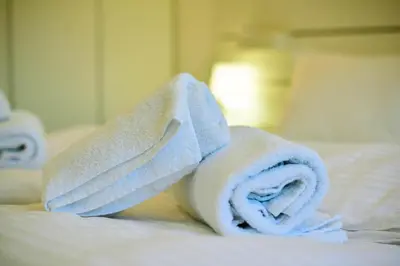 a pile of towels on top of a bed at Friendly Home ap Balkan-inn in Belgrade