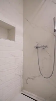 a bathroom with a shower with white marble at Friendly Home ap Balkan-inn in Belgrade