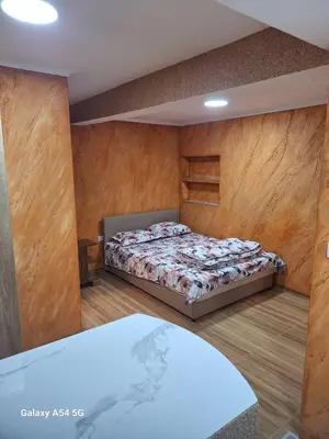 a bedroom with a bed in a room with wooden walls at Dream 5 in Belgrade