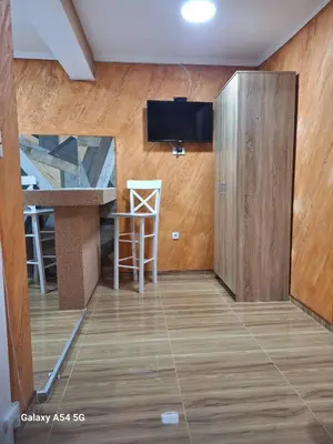a room with a kitchen and a bar with a tv at Dream 5 in Belgrade