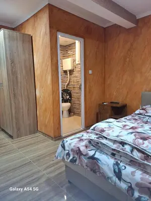 a bedroom with a bed and a bathroom with a toilet at Dream 5 in Belgrade