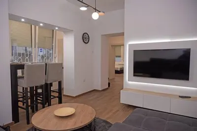 a living room with a large flat screen tv at Anmador Stay in Belgrade
