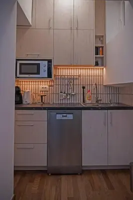 a kitchen with a sink and a microwave at Anmador Stay in Belgrade