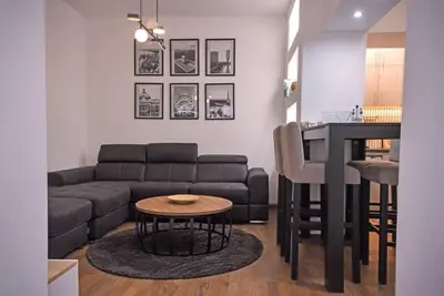 a living room with a couch and a table at Anmador Stay in Belgrade