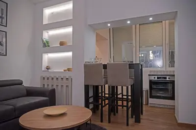 a living room with a couch and a table at Anmador Stay in Belgrade