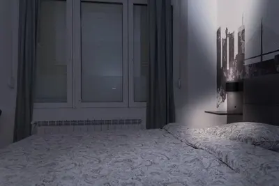 a bedroom with a large bed and a window at Anmador Stay in Belgrade