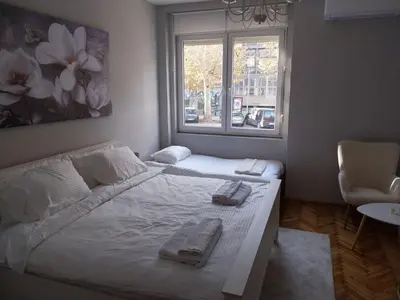 a bedroom with a bed with two towels on it at Maximus Apartments in Belgrade