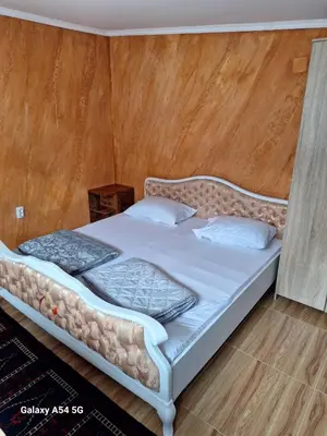 a bed in a room with a wooden wall at Dream 6 in Belgrade