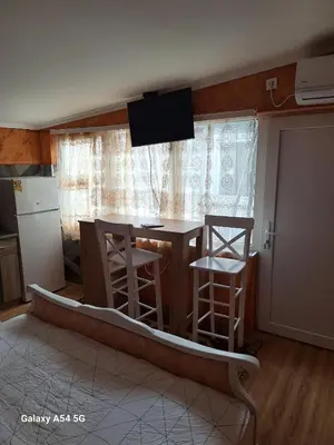 a kitchen with a table and two stools and a window at Dream 6 in Belgrade