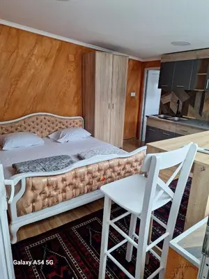 a bedroom with a bed and a table and a chair at Dream 6 in Belgrade