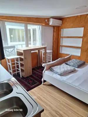 a bedroom with a bed and a sink and a table at Dream 6 in Belgrade
