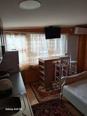 a small room with a kitchen with a table and a bar at Dream 6 in Belgrade