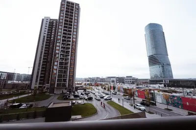 a city with two tall buildings and a street with cars at inJoy in Belgrade