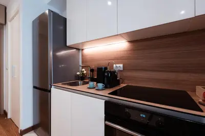 a kitchen with a sink and a refrigerator at inJoy in Belgrade