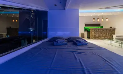 a bed in a room with blue lighting at Morning Wood - Skylight in Belgrade