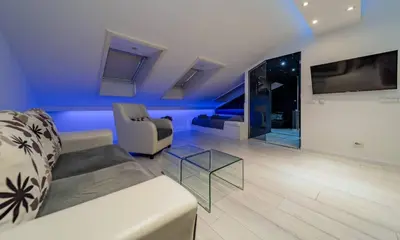 a living room with a couch and a glass table at Morning Wood - Skylight in Belgrade