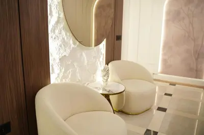 a room with two chairs and a table and a mirror at Heaven Luxury Suites in Belgrade