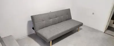 a gray bench sitting in a corner of a room at Kristian in Belgrade