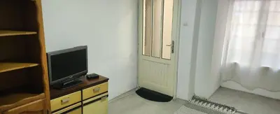a room with a tv on a dresser next to a door at Kristian in Belgrade