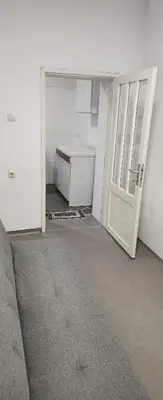an empty room with an open door and a couch at Kristian in Belgrade
