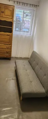 a bed sitting in a room next to a window at Kristian in Belgrade